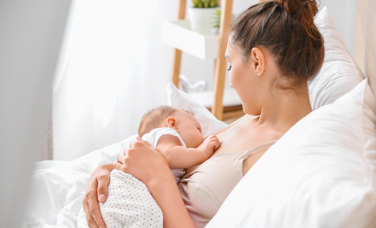 Young mother breastfeeding her baby, illustrating essential breastfeeding must haves for new moms.