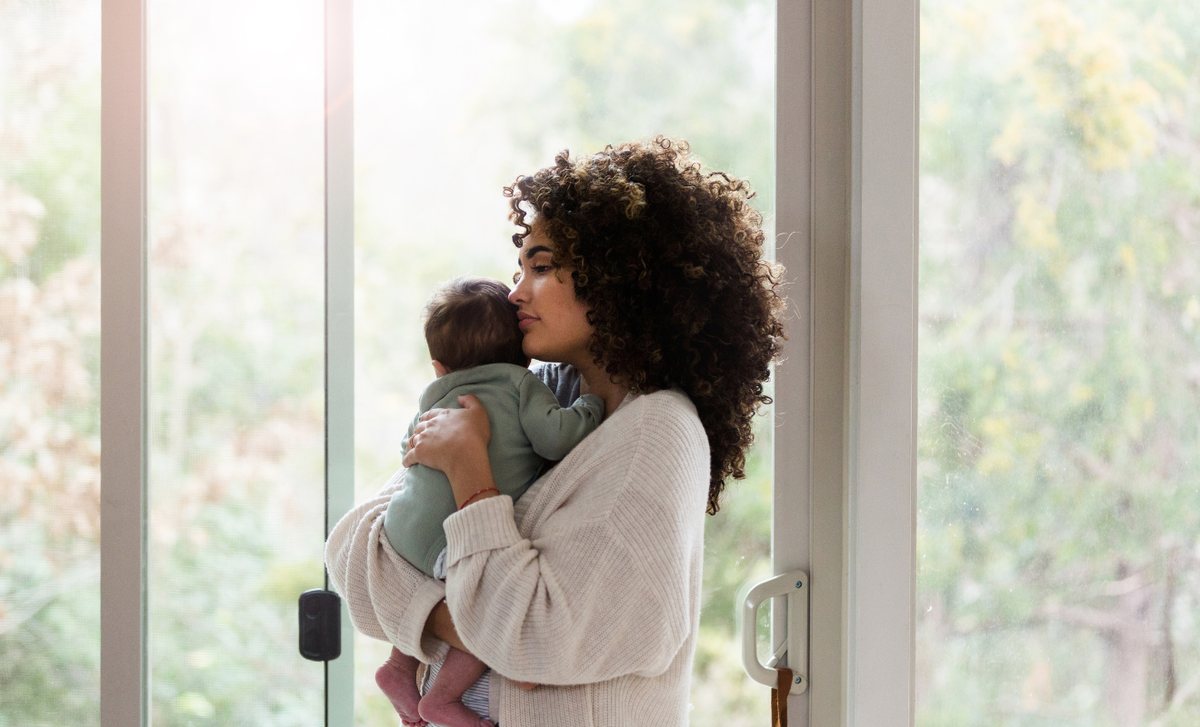 Woman holding a pregnancy test, representing the stress and hormonal changes discussed in how stress can affect fertility