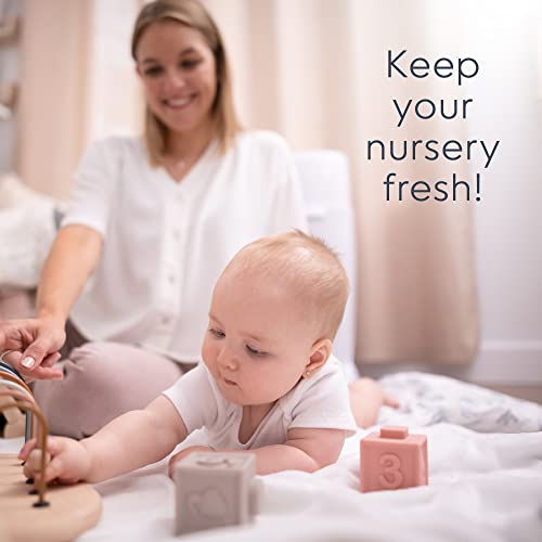 A baby playing with blocks while a parent watches, emphasizing how to keep your nursery fresh.