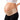 The AZMED maternity support belt in beige, worn under the bump and wrapped low across the hips, with the wearer's hand on her lower back.