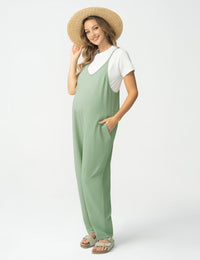 Maternity jumpsuit in soft green color with pockets, designed for comfort during pregnancy.