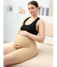 Postpartum shapewear shown on a pregnant woman sitting on a bed, offering smooth support during pregnancy.