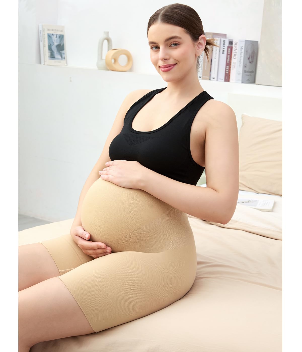 Postpartum shapewear shown on a pregnant woman sitting on a bed, offering smooth support during pregnancy.