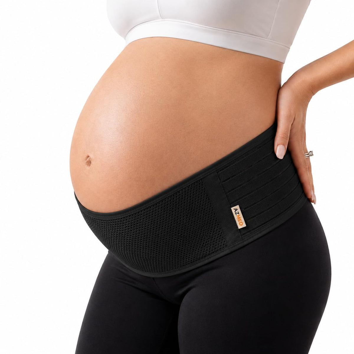 The belt in black, worn low across the hips beneath the bump, showing the wide front mesh panel and side fastening.