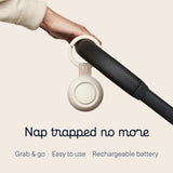 Hand holding Hatch Go portable sound machine for baby, designed for easy travel and use.