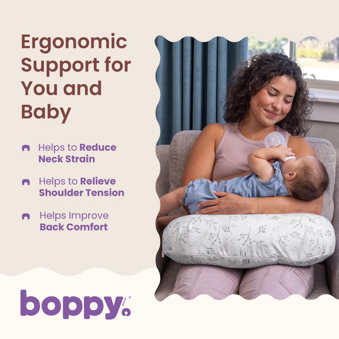 Boppy ergonomic support panel listing reduced neck strain, relieved shoulder tension and improved back comfort, beside a mother bottle-feeding in an armchair.