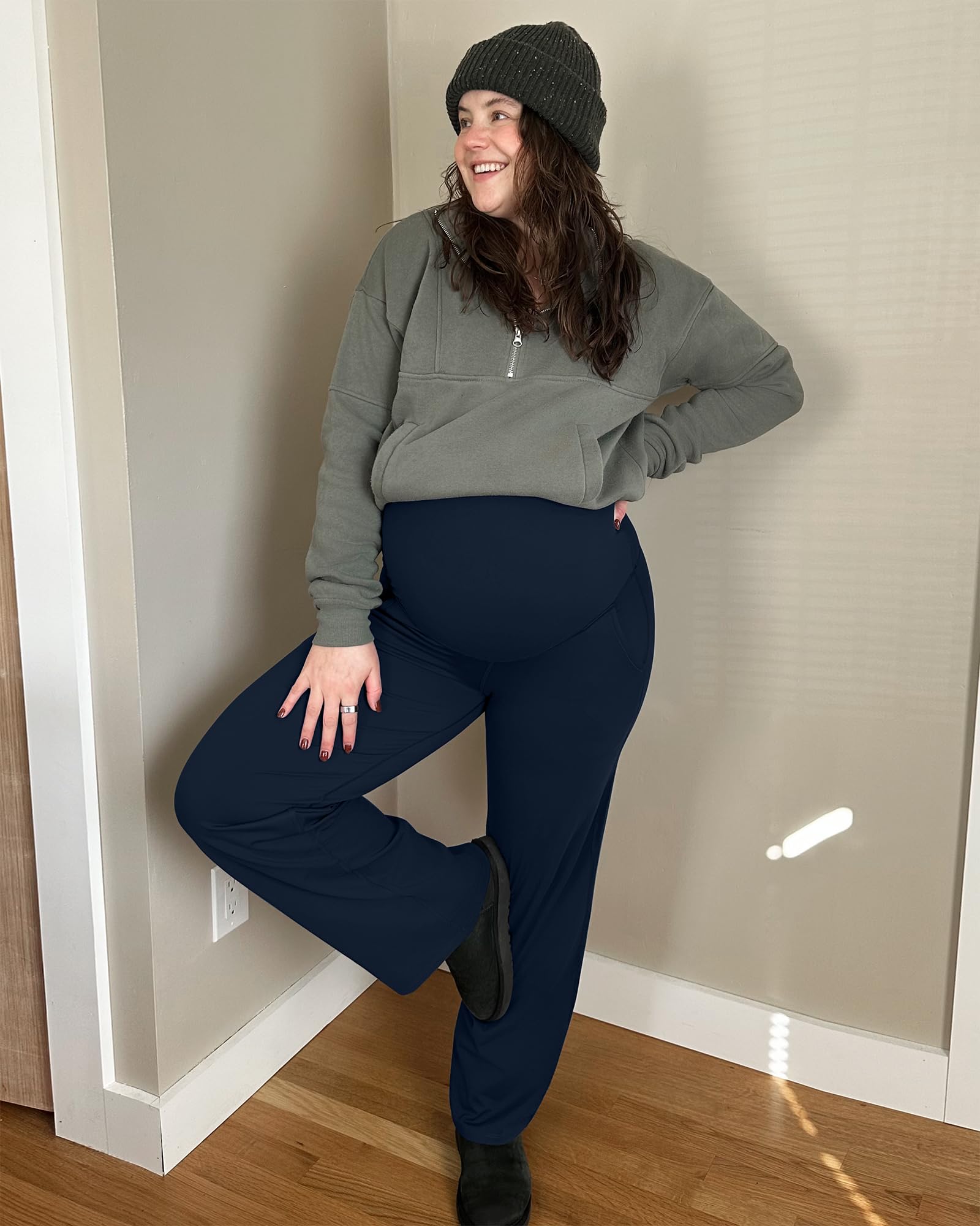 Woman wearing G4Free maternity leggings with over-belly support, styled with a casual outfit indoors.