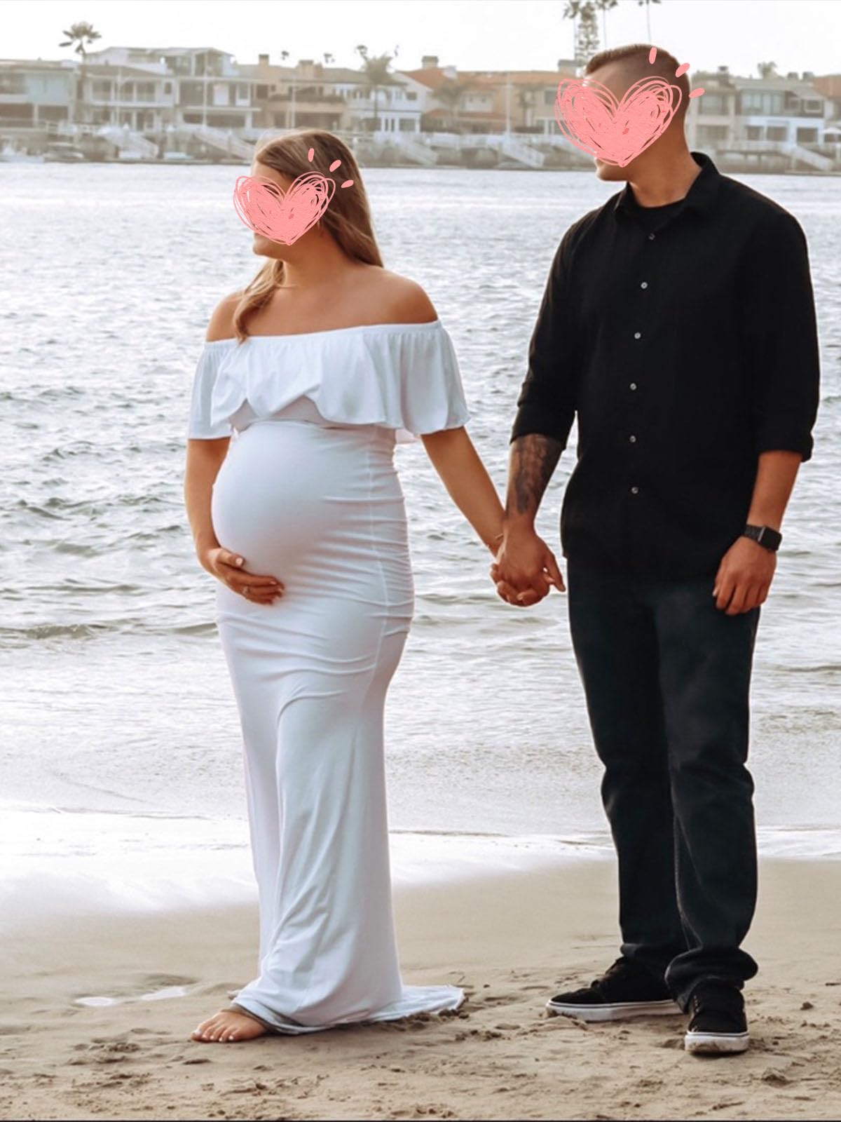 Couple holding hands by the beach in a maternity photoshoot dress, featuring the Glampunch Off-Shoulder Ruffle Gown.