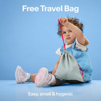 Toddler holding the grey drawstring travel bag that comes included with Alpine Muffy Baby earmuffs