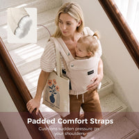 Mother walking downstairs with a toddler in the Momcozy PureHug carrier and its padded comfort straps