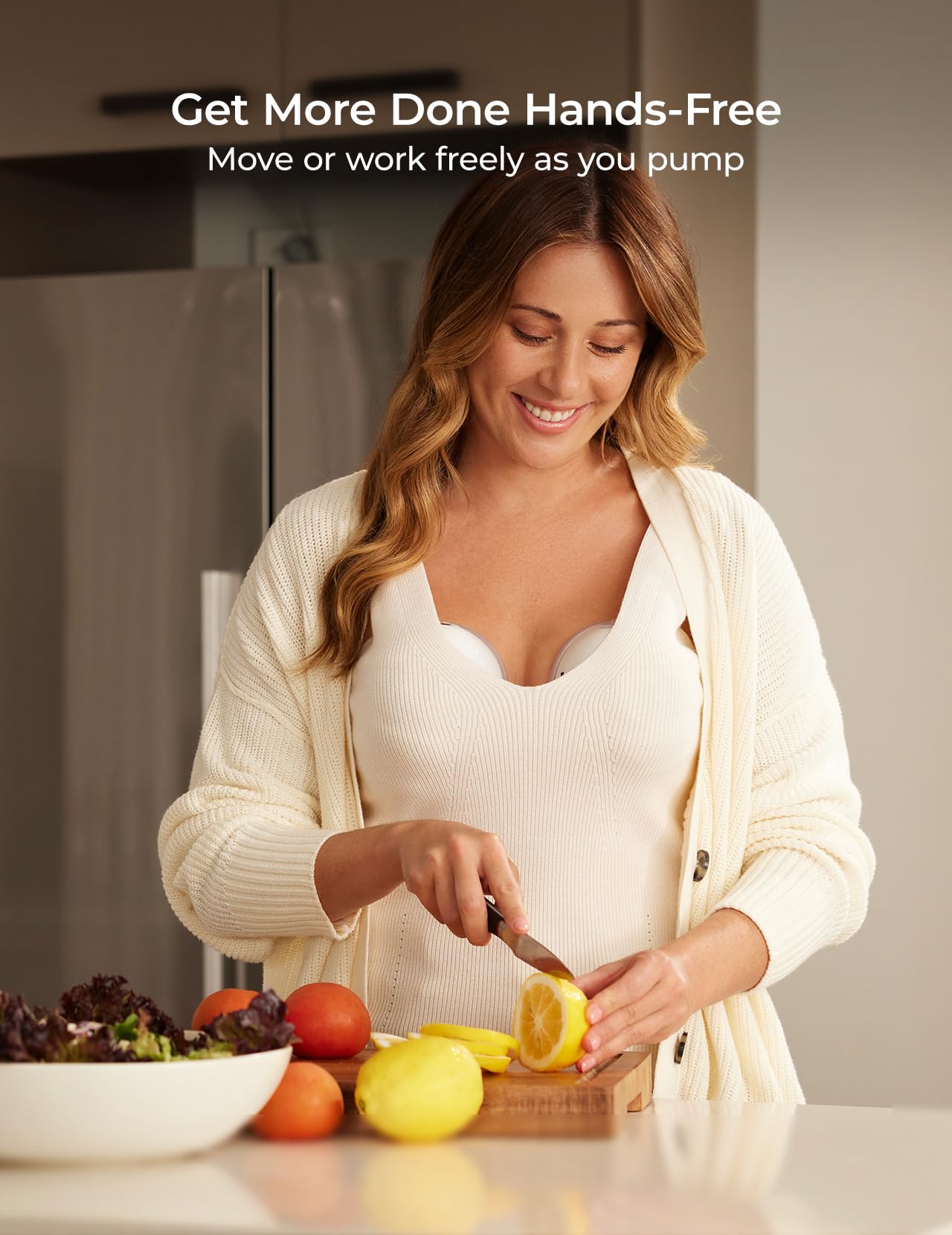 Mom using a hands free wearable breast pump while chopping lemons in the kitchen, showcasing convenience and multitasking.