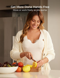 Mom using a hands free wearable breast pump while chopping lemons in the kitchen, showcasing convenience and multitasking.