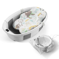 Collapsible baby bathtub with soft patterned insert and mesh storage bag, designed for easy baby bath time.