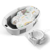 Collapsible baby bathtub with soft patterned insert and mesh storage bag, designed for easy baby bath time.