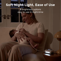 Momcozy baby nasal aspirator in use with soft night light, showcasing 3 brightness options for easy night-time use.