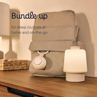 Bundle up portable sound machine for baby on a bedside table, perfect for sleep routines at home and while traveling.