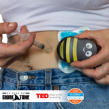 Needle pain relief for IVF injections using Buzzy Personal Vibrating Ice Pack on skin with syringe.