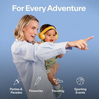 A parent holding a baby wearing yellow Alpine Muffy Baby earmuffs, with icons for parades, fireworks, travel and sporting events
