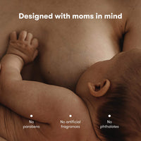 Mother breastfeeding baby, highlighting safe ingredients: no parabens, artificial fragrances, or phthalates.