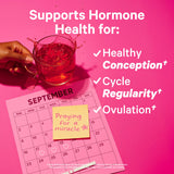 Fertility tea for women supporting hormone health for conception, cycle regularity, and ovulation with a pink background.