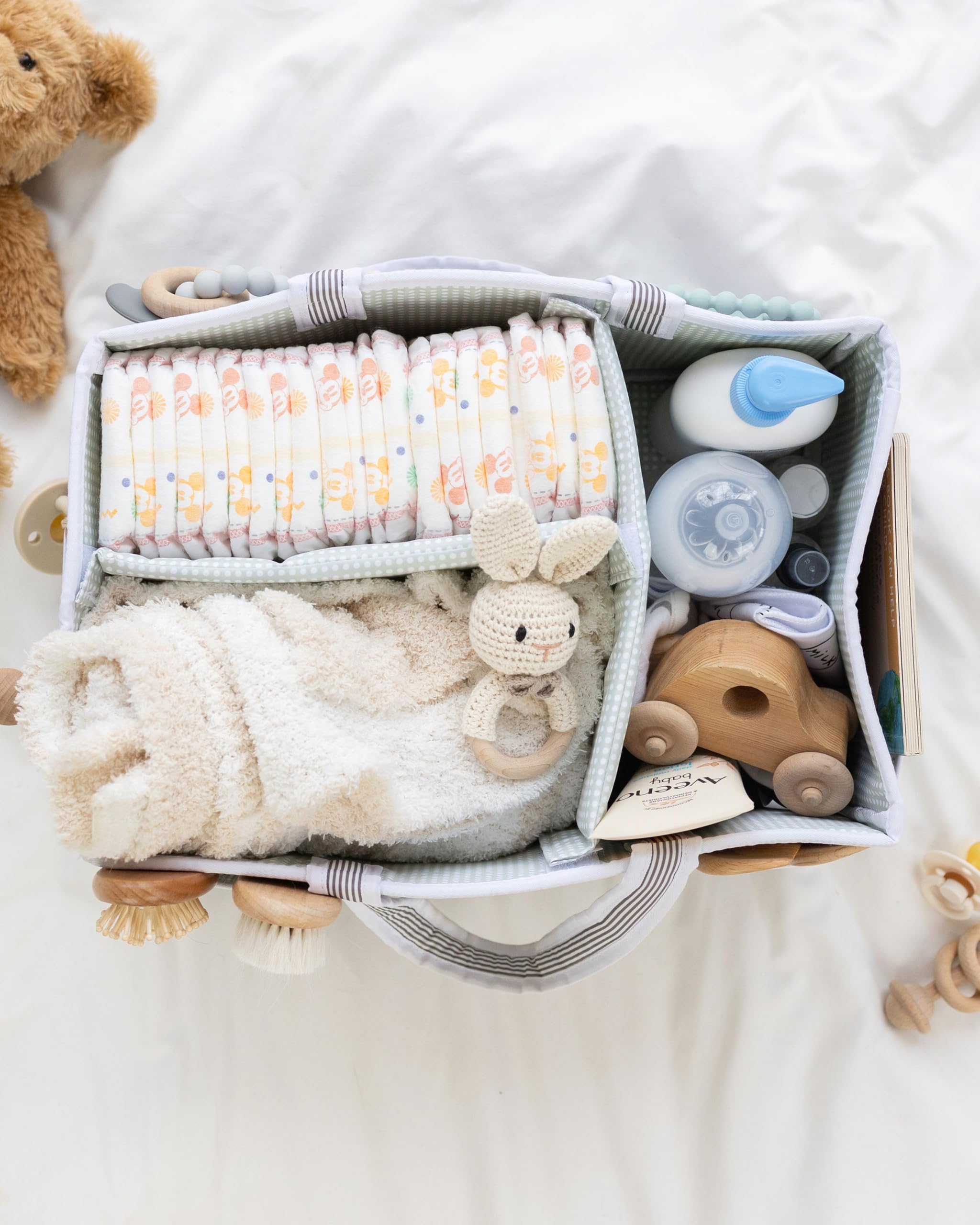 Lily Miles baby diaper caddy filled with diapers, baby toys, and essentials for newborn care.