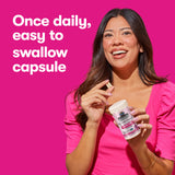 Woman holding Garden of Life Women’s Support probiotics for fertility, showcasing easy to swallow daily capsule.
