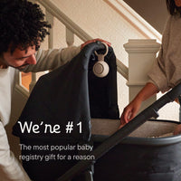 Two adults using the Hatch Go Portable Sound Machine for baby in a stroller, showcasing its portability.