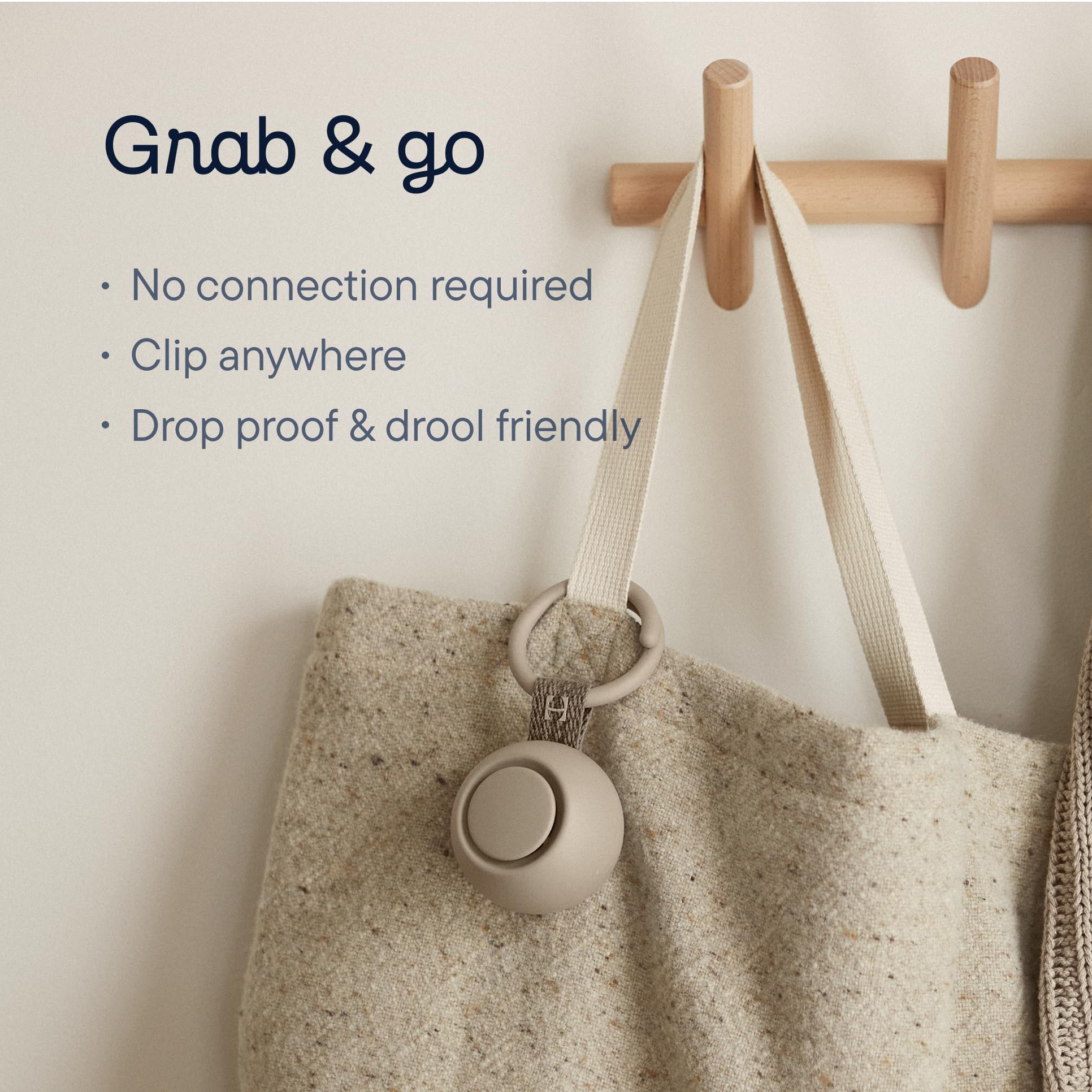 Portable sound machine for baby clipped on a bag for easy access and travel convenience.