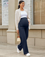 Maternity leggings styled with a white tank and cardigan, designed for comfort during pregnancy.