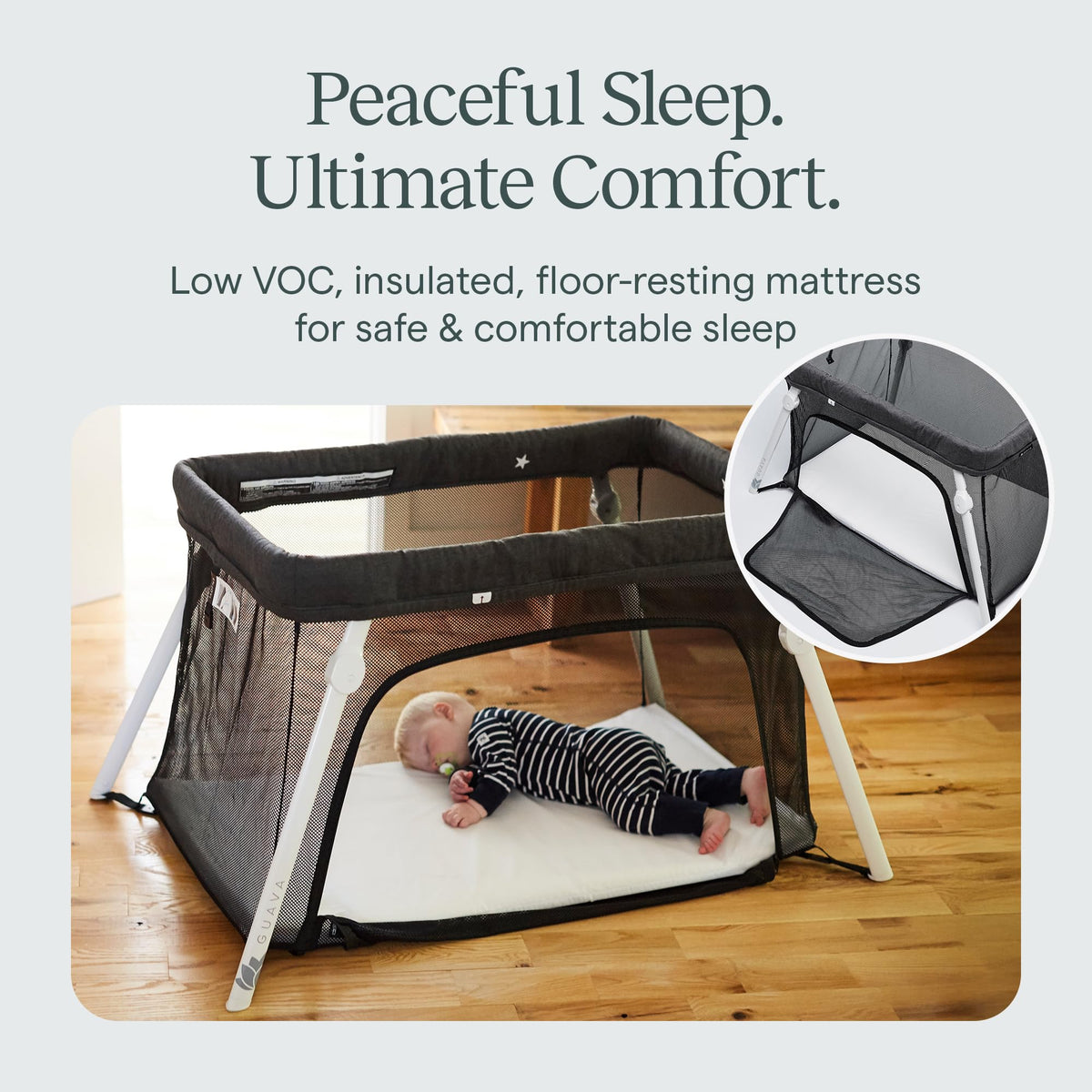 Baby asleep on the bare floor-resting mattress of the Guava Lotus travel crib