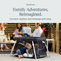 Family outdoors with a toddler playing in the Guava Lotus used as a play yard