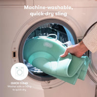 Machine-washable, quick-dry sling for baby bathtub by Frida Baby, placed in washing machine for easy cleaning.