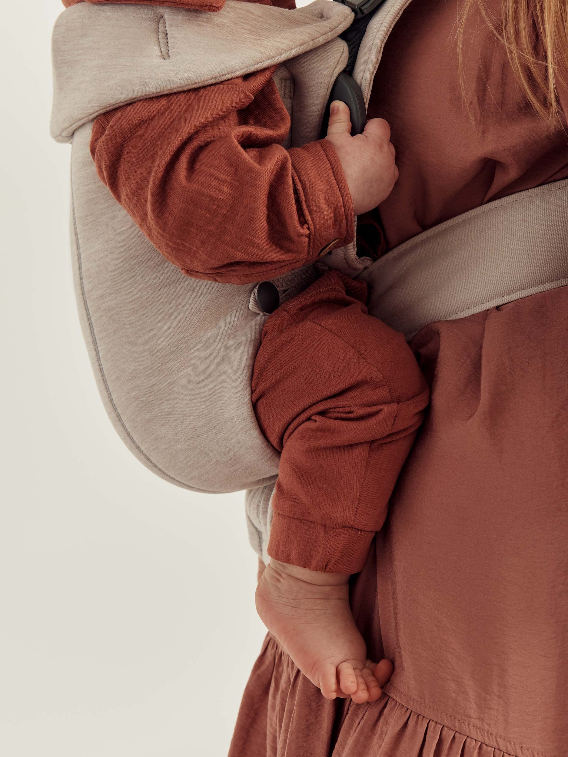 Baby carrier designed for newborns, showing a baby comfortably held in the BabyBjörn Mini Baby Carrier.