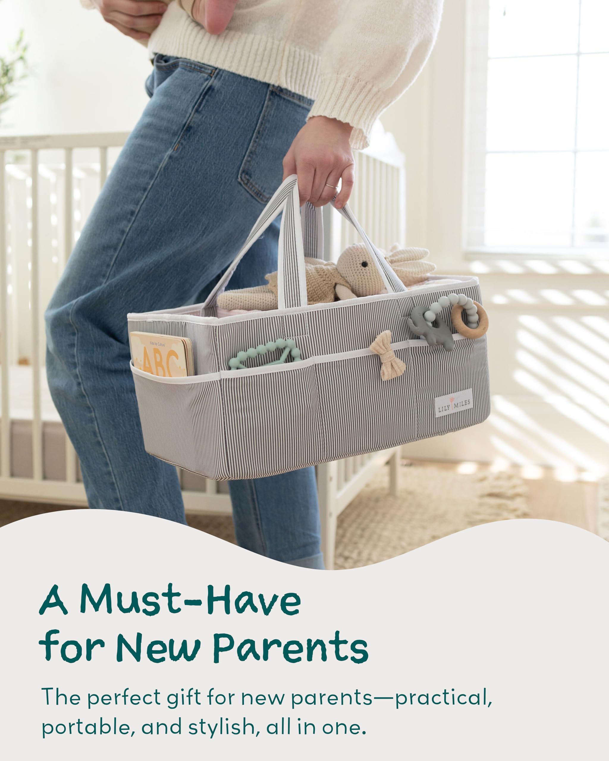 A person holding a Lily Miles baby diaper caddy, showcasing organization for newborn essentials.