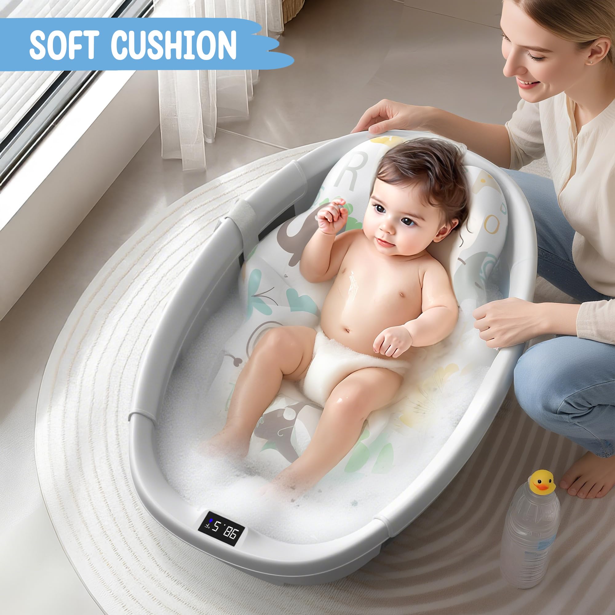 Baby enjoying a bath in a TOSGN collapsible baby bathtub with soft cushion and thermometer display.