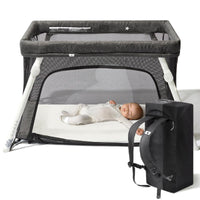 Guava Lotus travel crib set up with a baby on the floor-level mattress, next to its backpack carry bag