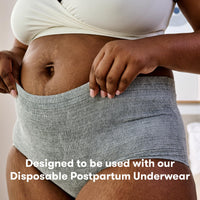 Person wearing grey postpartum underwear designed for use with postpartum pads for added comfort and protection.
