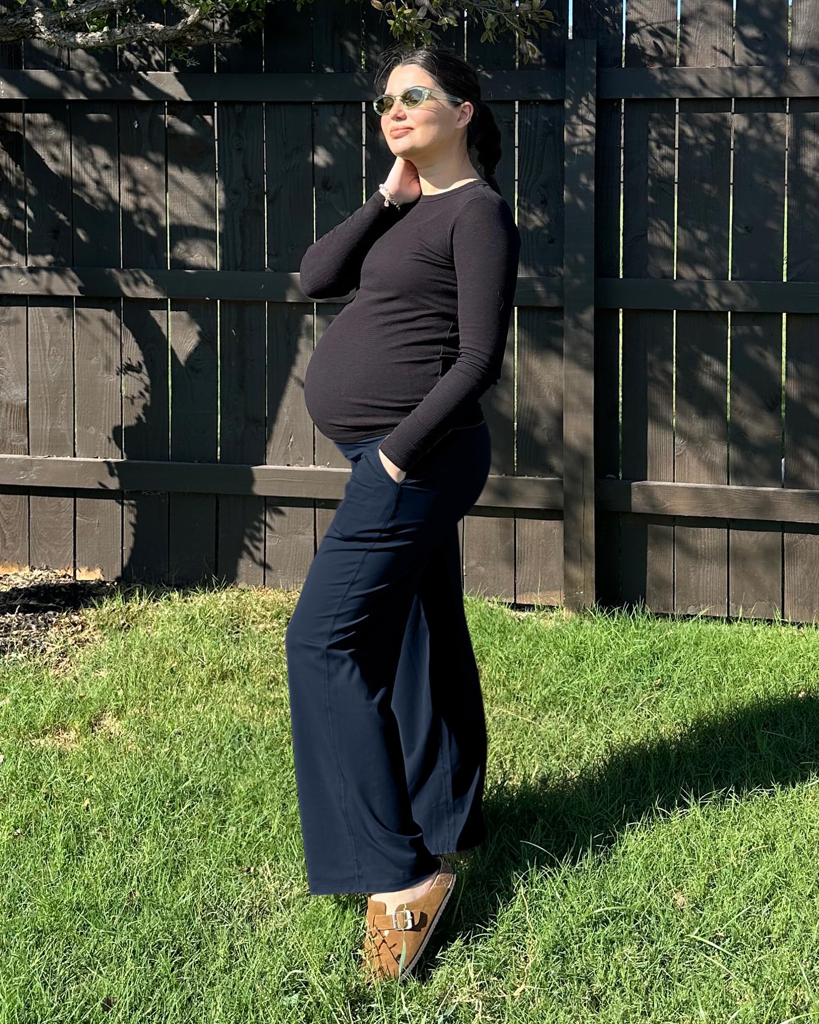 Maternity leggings model showing over belly support in a sunny outdoor setting, perfect for comfort during pregnancy.
