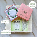 Fertility crystal bracelet with keepsake box and informational card, part of Mother’s Ray collection.