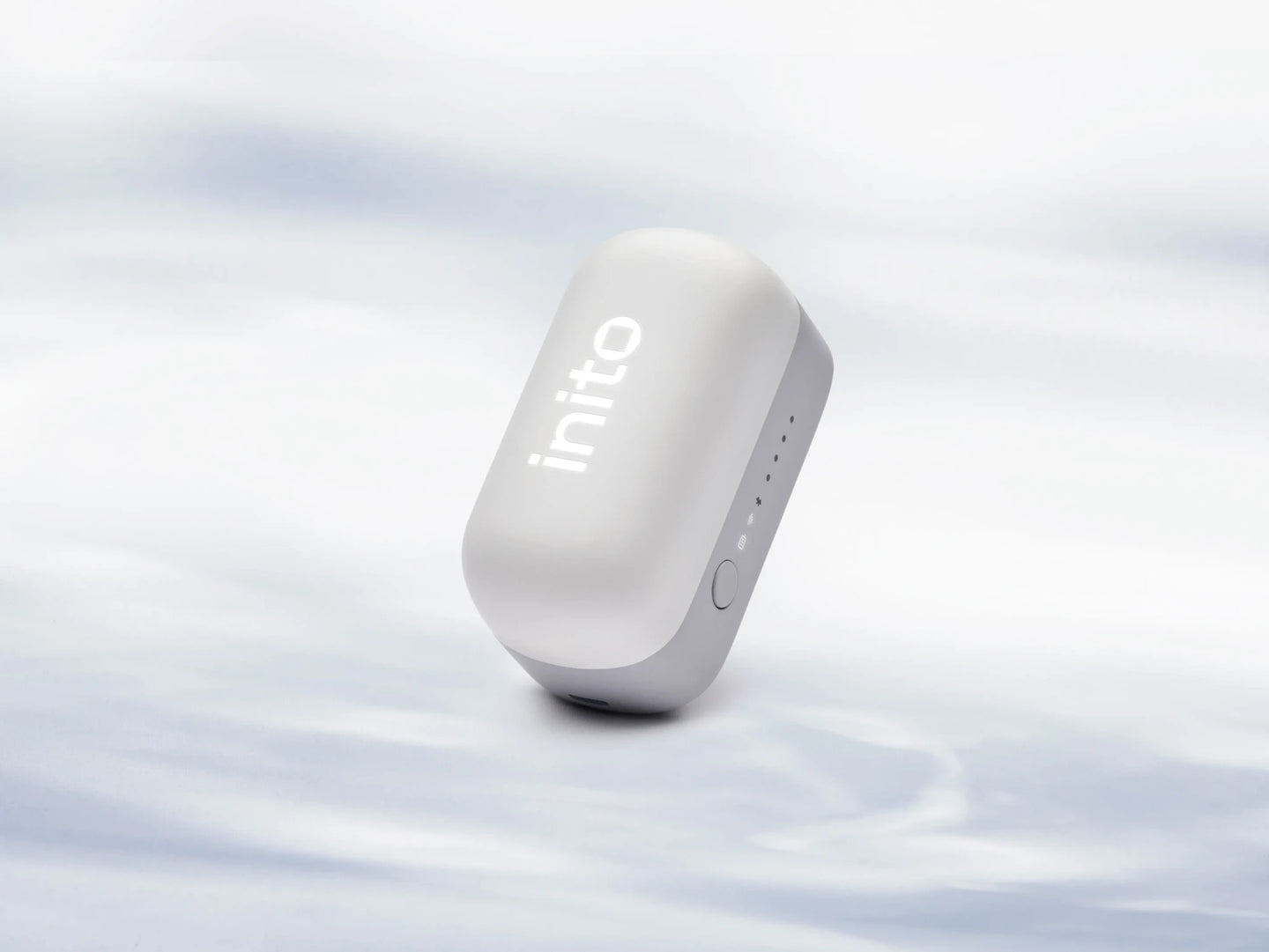 Inito fertility monitor with the InSight Wireless Reader and a fertility test strip